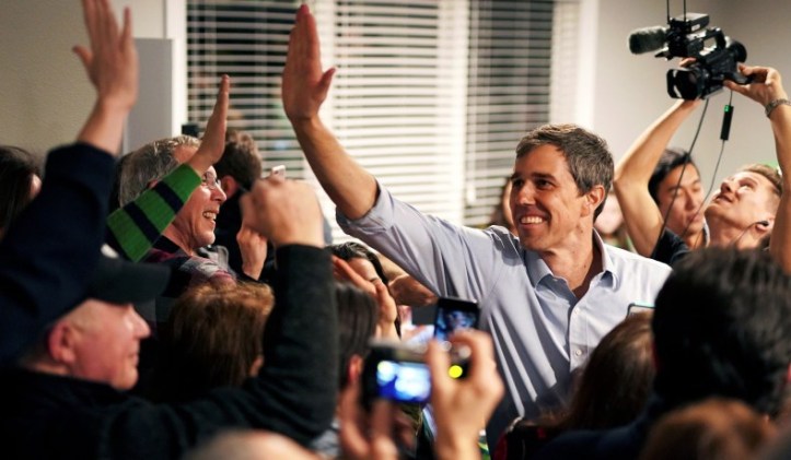 Democratic presidential candidate Beto O'Rourke, 46, high-fives supporters at a meet and greet during a three-day road trip across Iowa, in Dubuque